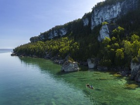 Towering limestone cliffs fall into crystal clear waters on the Bruce Peninsula, one of the many spectacular areas of Ontario’s Niagara Escarpment. Photo supplied.