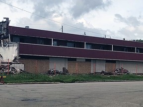 The demolition and clean-up of Manny's Motel has been put on hold until utilities on the property have been disconnected.