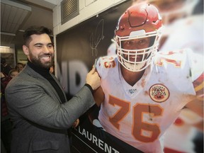 Laurent Duvernay-Tardif is all smiles after signing banner of himself, which was unveiled at the McGill sports centre on Wednesday, Feb. 12, 2020.