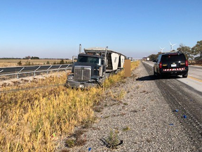 A tractor-trailer travelling westbound on Highway 401 near Mull Road in Chatham-Kent, Ont., hit the centre cable barrier after a tire blowout Sunday, Nov. 8, 2020. (Chatham-Kent OPP Photo)