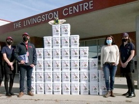 The rapid relief team in Tillsonburg donated 40 boxes of non-perishable food to the Oxford County Community Health Centre. From left are rapid relief team volunteers Kaitlyn Carpani, Kiara Prince, Roland Shaw, and Mikayla Shaw (far right) with Abbie Boesterd, OCCHC outreach worker. (Chris Abbott/Postmedia Network)