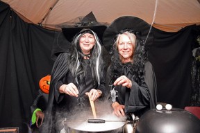 Volunteers Jackie Gnam (left) and Denise Bondaruk add plastic mice to their boiling cauldron during the Creepy Crawly Halloween Hoopla at the Fairview Legion Hall in Fairview, Alta. on Saturday, Oct. 31, 2020.