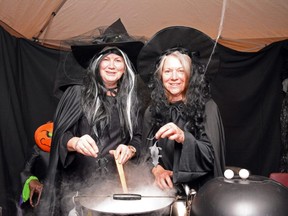 Volunteers Jackie Gnam (left) and Denise Bondaruk add plastic mice to their boiling cauldron during the Creepy Crawly Halloween Hoopla at the Fairview Legion Hall in Fairview, Alta. on Saturday, Oct. 31, 2020.