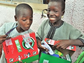 Chatham-Kent residents filled 2,501 shoeboxes last year during the 2019 Operation Christmas Child. Pictured are two boys in Senegal checking out their Canadian-packed Operation Christmas Child shoeboxes. Handout/Postmedia Network