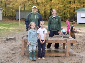 Norfolk Forest School is a child-led program where the kids can learn about whatever sparks their curiosity in nature that day. At the school on Oct. 28 were co-founders Bernie Solymár and Colleen Dale with six-year-old Charlotte Fitzgerald and five-year-old Foster Hastings. Ashley Taylor/Postmedia Network