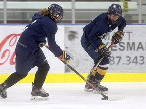 Peace Country Female Athletic Club U18 AA Storm teammates Kamryn Aebly (left) and Charlieze Sallis battle for the puck during practice on Tuesday night at the Coca-Cola Centre. The Storm finish the Alberta Female Hockey League pre-season this Saturday afternoon when the St. Albert Sharks come to town for a 2 p.m. game at the Coca-Cola Centre.