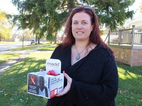 Erin Pollard, president of MADD Sarnia-Lambton, holds a Red Ribbon Project box that will be placed at local businesses through the holidays.