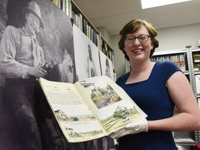 South Peace Regional Archives executive director Alyssa Currie holds one of two volumes of the painted 1933 diary of Olwen Sanger-Davies on Friday July 14, 2017 in Grande Prairie, Alta.