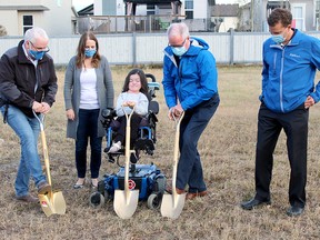 From left, Rick Lystang, Heather Forsyth, Pyper Whitecotton, Spruce Grove Mayor Stuart Houston and Coun. Dave Oldham break ground for Whitecotton and mother Forsyth's new home on Aspenglen Drive in Spruce Grove Tuesday. The pair began fundraising for a new residence in 2019 after outgrowing the mobile home they lived in.