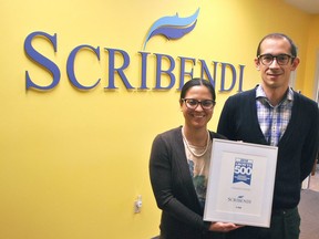 Scribendi president Patricia Riopel and CEO Enrico Magnani hold up their award for making the Growth 500 Canada's Fastest Growing Companies list in Canadian Business magazine at their Chatham office in 2018. The company has made the list again in 2020. Canadian Executive Search Group, another Chatham business, also made the list. (Tom Morrison/Postmedia Network)