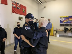 Betty Burt hugs family friend and deputy fire chief Stephen Jaworski during a special ceremony, Wednesday, at the Phelps Volunteer Fire Brigade. Her husband Tom Burt was recognized for his 25 years of service, including 19 as fire chief. He is stepping down due to health reasons.