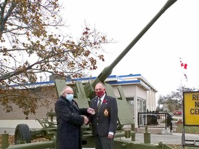 Les Burden, president of the Tillsonburg Military History Club, left, presents a local hero award to Don Burton, the chair of the Tillsonburg Legion Branch 153 poppy campaign. Burton was pivotal in refurbishing the 1943 40mm anti-aircraft gun in front of the Tillsonburg Legion. (Chris Abbott/Norfolk and Tillsonburg News)