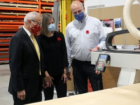 Nipissing MPP Vic Fedeli talks to Grace and Michael Valenti, Monday, at Designed Roofing in North Bay. The company is among five in the region which will receive $1.4 million through the Northern Ontario Heritage Fund Corp.
PJ Wilson/The Nugget