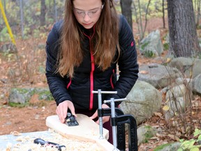 Autum Webster, a Grade 6 student at Mattawa District Public School, planes the paddle she is making as part of a school project.
Submitted Photo.