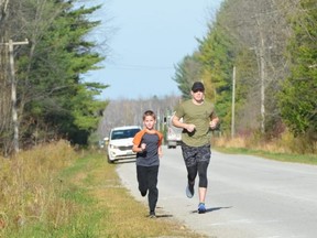 Jake Ireland of Southampton runs with his cousin Nate, 9, on Saturday, November 7, 2020 near Saugeen First Nation. Ireland ran 28 miles on Saturday to raise some funds to help his aunt, who is battling cancer.