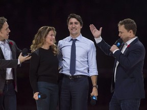WE co-founders Craig (left) and Marc Kielburger introduce Prime Minister Justin Trudeau and his wife, Sophie Gregoire-Trudeau, as they appear at the WE Day celebrations in Ottawa in 2015. In the WE controversy, the Canadian government tried be a philanthropist, using public money, writes Sault Star columnist Gene Monin. THE CANADIAN PRESS/Adrian Wyld