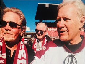 Doug Falconer, left, with Jeopardy! host Alex Trebek at the 2019 Panda Game at TD Place stadium at Lansdowne Park.