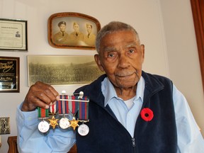 John Olbey, 98, earned several medals while serving as a Sergeant in the 4th Canadian Armoured Division/Headquarters during the Second World War. He is snown on the left in the photo behind him with his brothers George, in the middle, who served in the Signal Corps, and Wilfred, who served in the forestry unit in British Columbia. Olbey is also in the group photo of the Fourth Canadian Armoured Brigade take in June 1944 in Marsfield, England. Ellwood Shreve/Postmedia Network