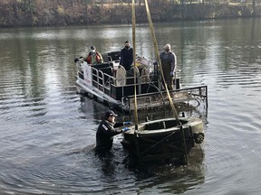 Tillsonburg Kinsmen Club's Jush Matheson helps guide the Lake Lisgar fountain from the water during its removal for winter storage on Oct. 31st. (Submitted photo)