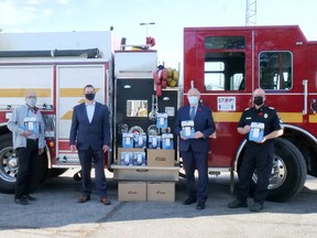 Tillsonburg District Real Estate Board and their community sponsors presented 67 carbon monoxide alarms to Tillsonburg Fire and Rescue Services Monday morning - with a few more still coming. From left are Walter Kleer and Marcel Vandehoef, from the TDREB Community Programs Committee, Oxford MPP Ernie Hardeman, and Tillsonburg Fire Chief Brad Lemaich. (Chris Abbott/Norfolk and Tillsonburg News)