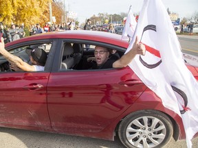 Protesters flying flags of a group called "The Line" arrive at the East Elgin Community Centre to protest against public health measures in Aylmer on Nov. 7. The Line bills itself as a civil liberties group resisting tyranny and oppression. The Line organized convoys of protestors from London and Mississauga. Derek Ruttan/Postmedia Network