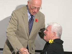 Brian O'Rourke (left) congratulates Dennis Fairall at Fairall's Tillsonburg Favourite Son award ceremony in October 2016. (Chris Abbott/Norfolk and Tillsonburg News)