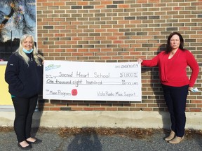 Sacred Heart principal Syndy Withers was happy to receive a cheque for $1,800 for the school music program, from Rosalind Russell morning host and regional reporter for Moose 99.3 FM.