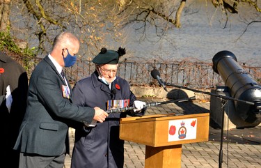 Rick Boon helps his father and Second World War veteran Art Boon, 95, to the Remembrance Day podium to announce the laying of the wreaths. Galen Simmons/The Beacon Herald/Postmedia Network