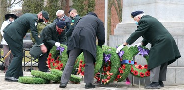 Remembrance Day service at cenotaph on Queen Street East in Sault Ste. Marie, Ont., on Wednesday, Nov. 11, 2020. Strong winds repeatedly blew down wreaths. (BRIAN KELLY/THE SAULT STAR/POSTMEDIA NETWORK)
