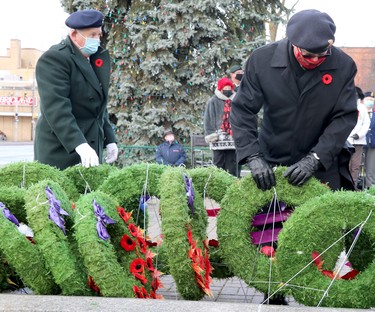 Remembrance Day service at cenotaph on Queen Street East in Sault Ste. Marie, Ont., on Wednesday, Nov. 11, 2020. Strong winds repeatedly blew over wreaths. (BRIAN KELLY/THE SAULT STAR/POSTMEDIA NETWORK)