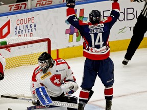 Team Slovakia's Dominik Jendek (14 jubilates after scoring on Team Switzerland goalie Sascha Ruppelt during first-period game action at the Hlinka Gretzky Cup hockey tournament in Edmonton on August 8, 2018.