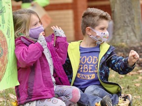 Hamlet public school students Vivian Bohnen and Chase Mayer show their support Friday for Cedarcroft residents and staff. Cory Smith/The Beacon Herald