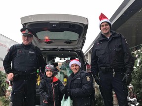 In the midst of pandemic, the Stratford Police Service announced it will carry forward with its annual toy and food drives in Stratford and St. Marys this holiday season. Pictured are members of the Stratford Police Service during its Stuff-a-Cruiser toy drive event last year. Submitted photo