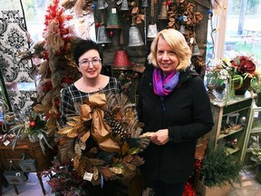 Melodee Delrue, owner of Syd Kemsley Florist, left, and Marianne Johnstone from IODE Captain Garnet Brackin hold up a wreath inside Delrue's Chatham store Oct. 30, 2019. The 2020 edition has been replaced with a series of draws at participating florist and plant businesses. (Tom Morrison/Postmedia)