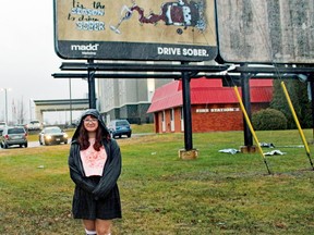 Taylor Laing stands in front of the billboard she designed to remind motorists to drive sober.
PJ Wilson/The Nugget