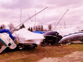 The Wind Seaker at left and a dozen other boats in the Harbour Marina in Port Dover got more than they bargained for Sunday as a fierce gale blew through southern Ontario. The storm caused widespread power outages and extensive damage, especially along lakeshore areas. – Monte Sonnenberg