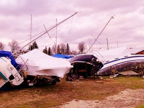 The Wind Seaker at left and a dozen other boats in the Harbour Marina in Port Dover got more than they bargained for Sunday as a fierce gale blew through southern Ontario. The storm caused widespread power outages and extensive damage, especially along lakeshore areas. – Monte Sonnenberg