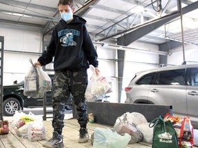 Volunteer Jadin Vandenberghe sorts donations during a Lambton County-wide food drive on Nov. 7 in Petrolia. Terry Bridge/Postmedia Network