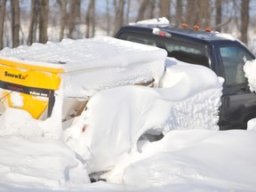 A salt truck sits buried in a snow drift on the side of westbound Highway 402 on Dec. 15, 2010 after a blizzard stranded hundreds of motorists. New windbreaks have been planted on the highway to held control drifting snow in the future. File photo/Sarnia Observer