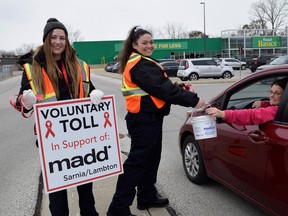 Volunteers collect money during MADD Sarnia/Lambton’s annual Voluntary Toll fundraiser in this file photo. Due to COVID restrictions, instead of the Voluntary Toll fundraiser in 2020, MADD will instead be hosting a Cashier Ask fundraiser at four Lambton County grocery stores this Nov. 21.File photo/Sarnia This Week