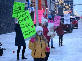 Dancers rally against provincial health restrictions in front of Diverse Dance Company along 100 Avenue in Grande Prairie, Alta. on Monday, Nov. 16, 2020.
