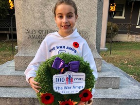Megan Mantha, 9, of Pembroke lays a wreath at the cenotaph on behalf of The War Amps. Submitted photo