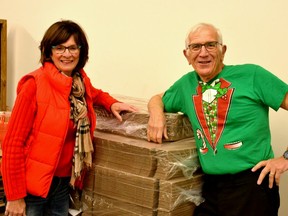 Ruth and Richard Kneider of Simple Dreams Ministries stand next to the nearly 1,000 takeout boxes at The Local Community Food Centre that they and their volunteers will be using to deliver this year's To Stratford With Love, free holiday meal on Dec. 19. (Galen Simmons/The Beacon Herald)