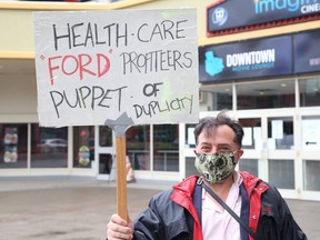 Alessandro Presenza takes part in a protest organized by the Sudbury chapter of the Ontario Health Coalition, in Sudbury on June 24. John Lappa/Postmedia Network