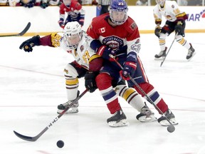 Timmins Rock defenceman Eric Moreau reaches in to knock the puck off the stick of Rayside-Balfour Canadians forward Gavin Brown during NOJHL action at the Chelmsford Arena Thursday night. The Rock rallied to score a 2-1 shootout victory over the Canadians. The Rock will host the Canadians at the McIntyre Arena Saturday night in their home opener. They will then do battle again Sunday night at the McIntyre Arena. BEN LEESON/POSTMEDIA NETWORK