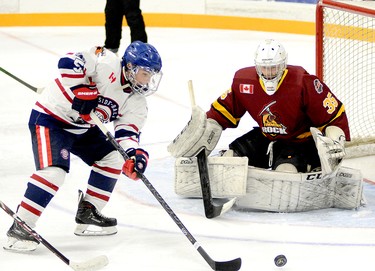 Rayside-Balfour Canadians forward Nicholas Faught tries to gain control of a rebound in front of Timmins Rock goalie Tyler Masternak during the first period of Sunday night’s NOJHL contest at the McIntyre Arena. Masternak stopped all 20 shots he faced to record his NOJHL-record 17th career shutout as the Rock went on to blank the Canadians 2-0, sweeping their two-game weekend series. THOMAS PERRY/THE DAILY PRESS/POSTMEDIA NETWORK