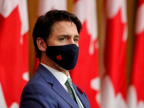 Canadian Prime Minister Justin Trudeau listens while wearing a mask at a news conference held to discuss the country's COVID-19 response in Ottawa on Nov. 6. PATRICK DOYLE/REUTERS