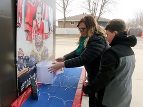 Erin and Cole Breadmore set up a memorial at Memorial Gardens for a vigil by classmates, Saturday. PJ Wilson/The Nugget