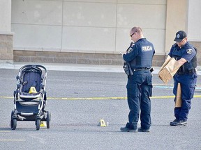 Greater Sudbury Police officers collect evidence at the site of a stabbing last year at the Michaels store on Marcus Drive. Alex Stavropoulos stabbed a woman and injured her baby. Jim Moodie/The Sudbury Star SUNMEDIA