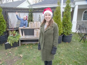 The chair of the Bayfield and Area Chamber of Commerce, Leanne Kavanagh, and Bayfield's councillor on the Municipality of Bluewater Council pose at the Christmas themed "social distance selfie station" set up in front of the library in Bayfield. Derek Ruttan/Postmedia staff